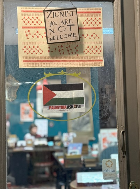 The door to a bookshop in downtown Bilbao reads: 'Zionists not welcome' (Azad Essa/MEE)