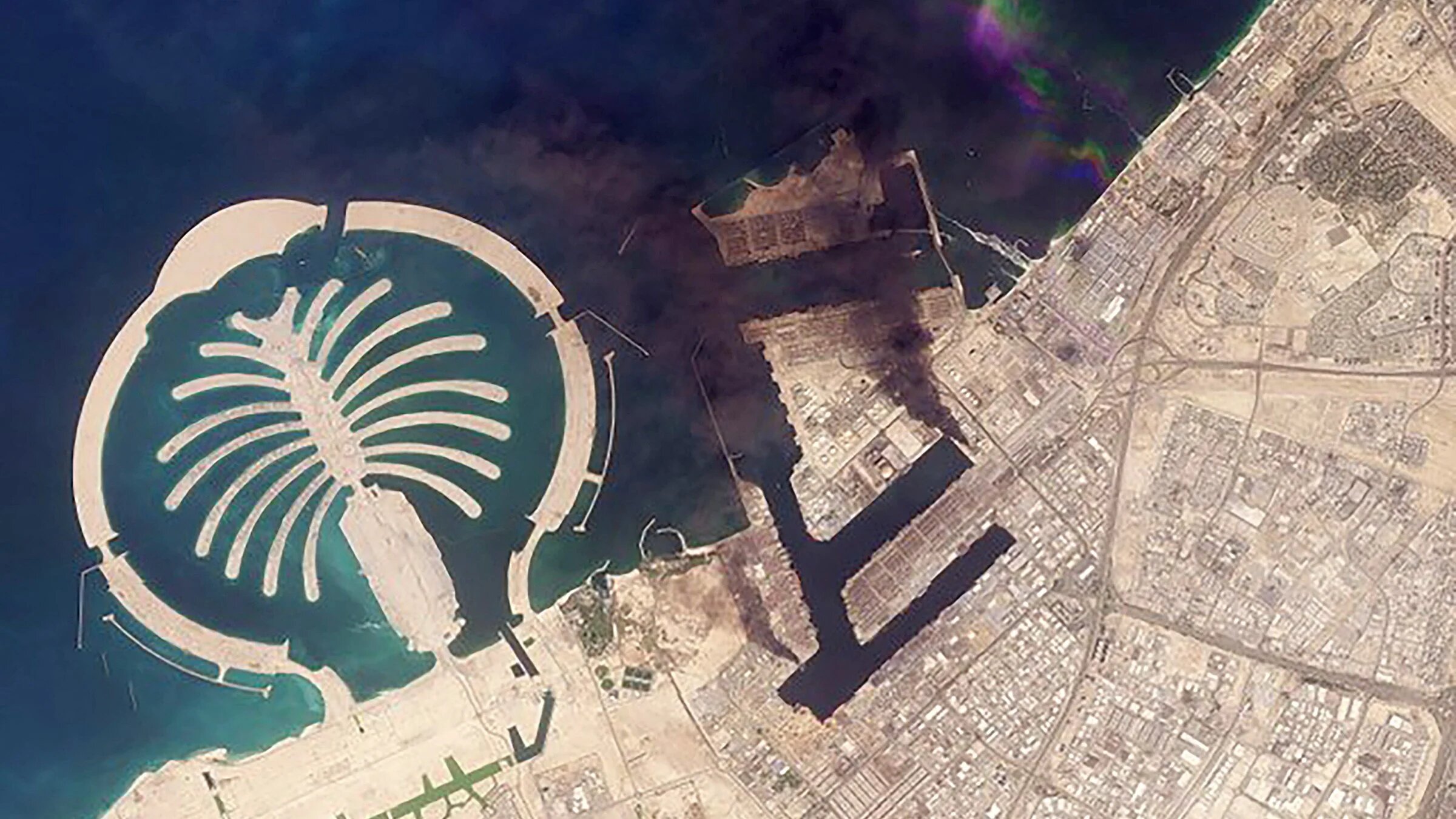 Smoke plumes billowing in Dubai after a projectile strike on 2 March 2026 (Planet Labs PBC/AFP)