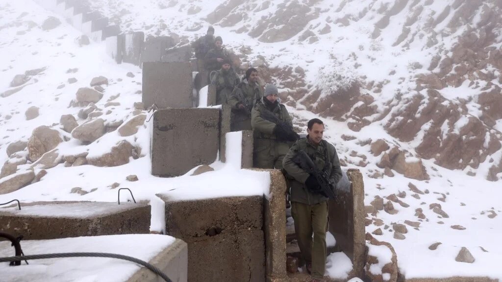 Israeli soldiers patrol the top of Mount Hermon near the border with Lebanon in the Israel-annexed Golan Heights on November 20, 2023 (Jalaa Marey / AFP)