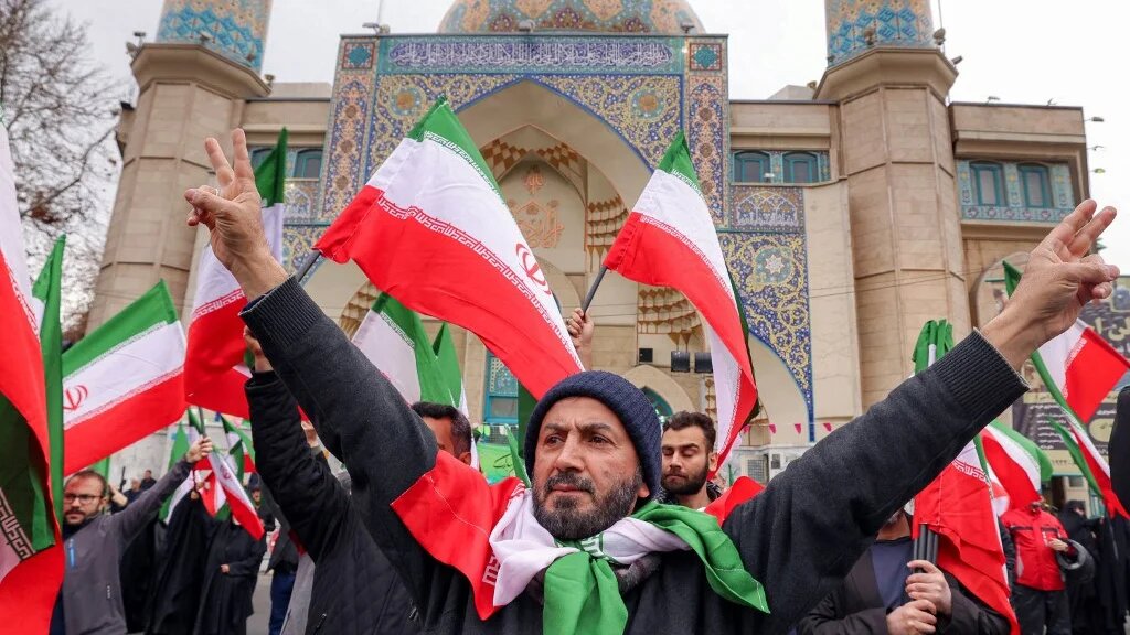 Protesters gather with Iranian national flags during a demonstration in support of the government and against US and Israeli strikes, in Tehran on 28 February 2026 (Atta Kenare/AFP)
