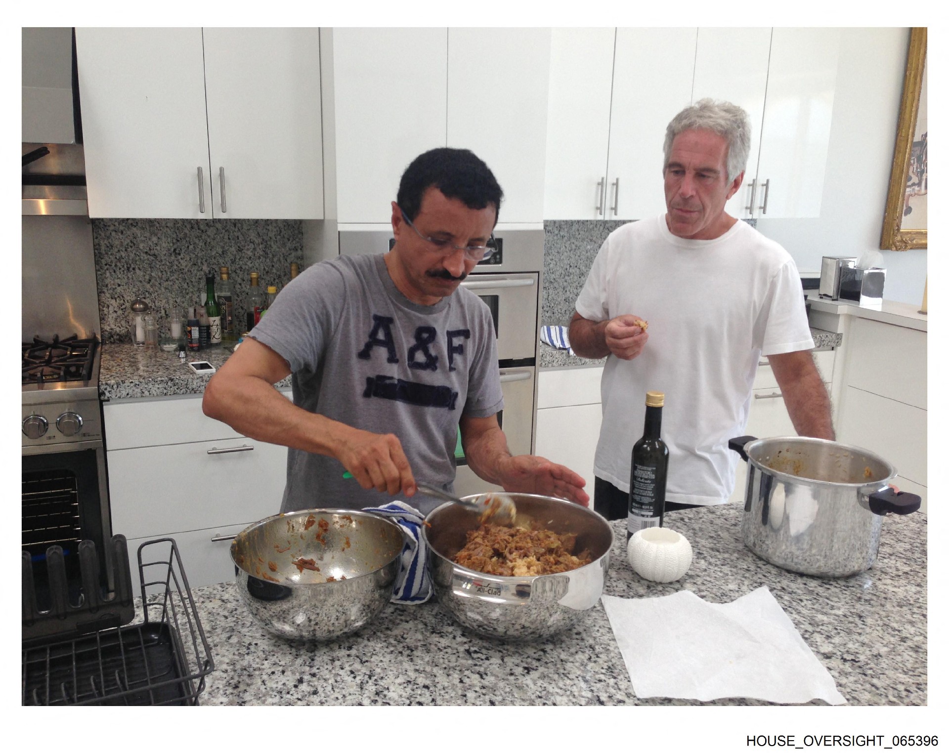 This undated and unlocated handout image released by Democrats on the House Oversight Committee shows Jeffrey Epstein (R) cooking with Sultan Ahmed bin Sulayem (House Oversight Democrats/AFP)