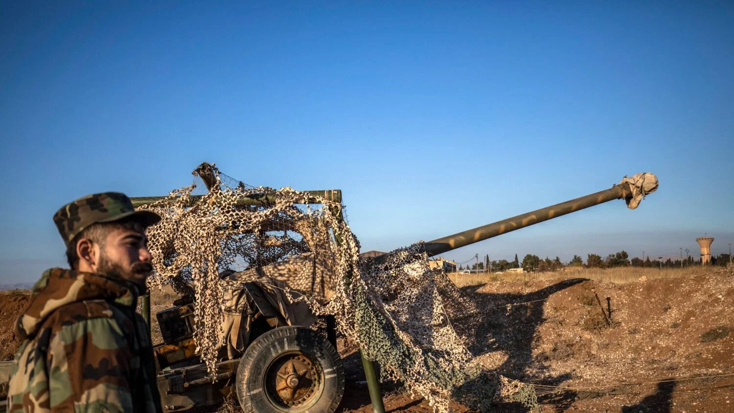 Fighters with the Kurdish-led Syrian Democratic Forces (SDF) inspect damaged and abandoned military vehicles and equipment at the Qamishli international airport on 9 December 2024.