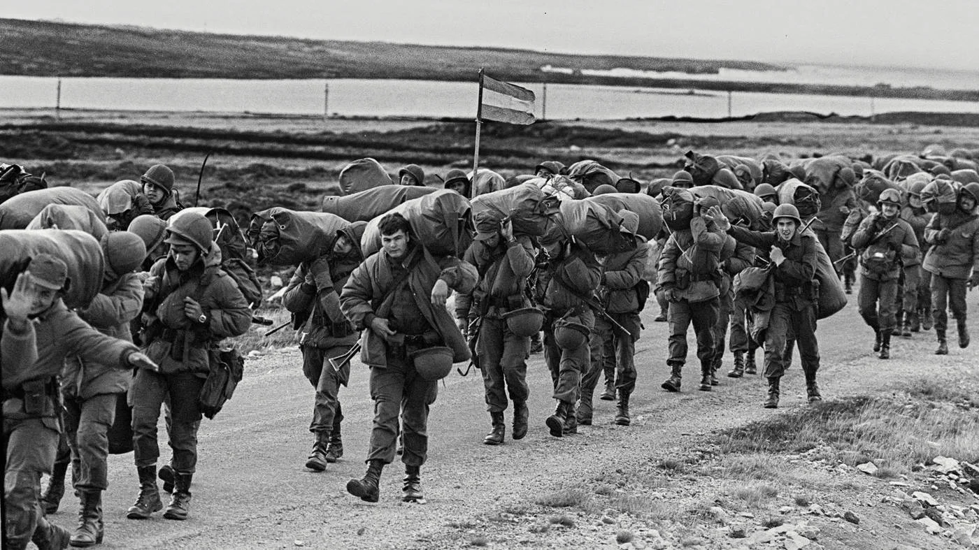Argentine soldiers advance on Port Stanley on 13 April 1982 following ther invasion of the Falkland Islands (AFP)