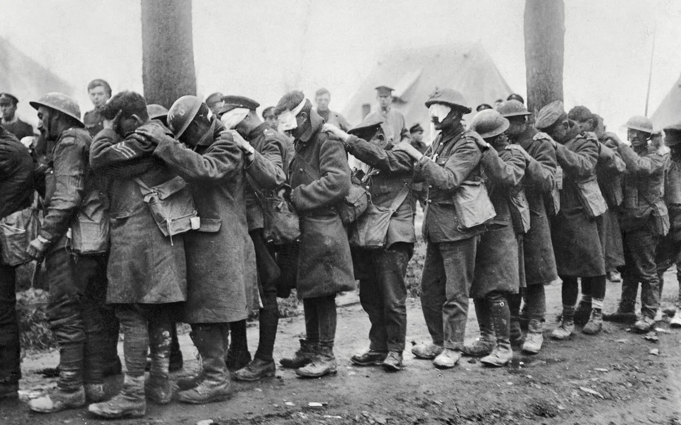 April 1918: British soldiers blinded by gas wait for treatment near Bethune, France. The use of chemical gas is now regarded as a war crime (Imperial War Museums / HMSO)