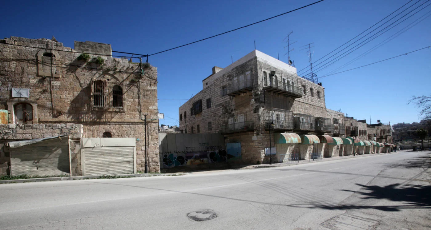 Al-Shuhada Street, pictured here in February 2014, leads up to the Ibrahimi Mosque and once the heart of Hebron until Palestinians were forced out (AFP)