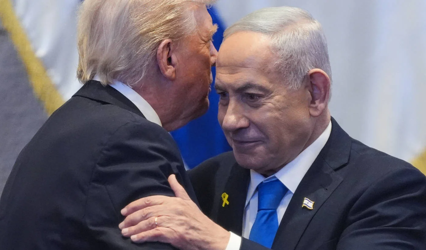 US President Donald Trump (left) whispers to Israeli Prime Minister Benjamin Netanyahu at the parliament building in Jerusalem on 13 October 2025 (AFP)